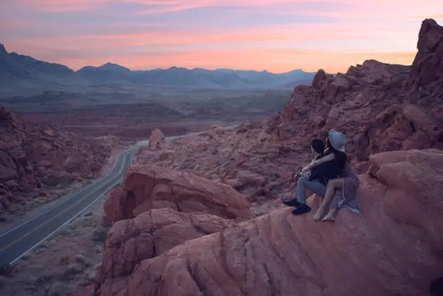 couple sitting down watching sunset