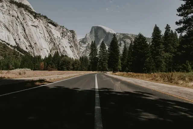road leading towards a giant mountain