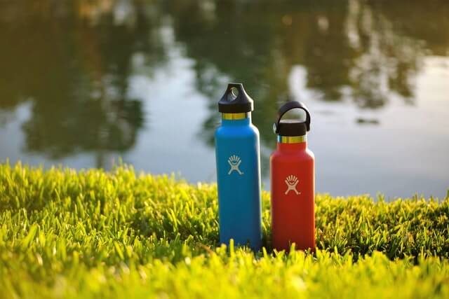 two water bottles on the grass