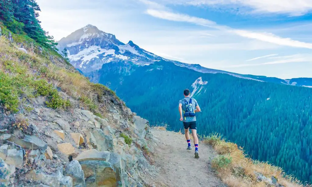 hiker running on trail