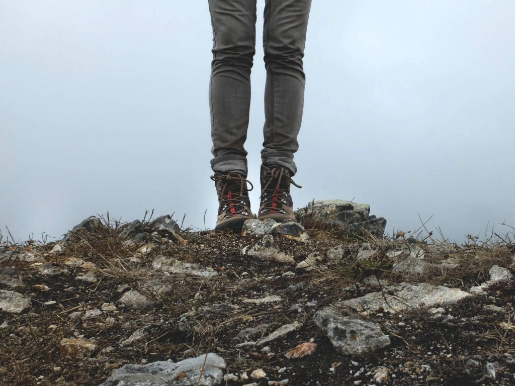 hikers legs standing on rocks