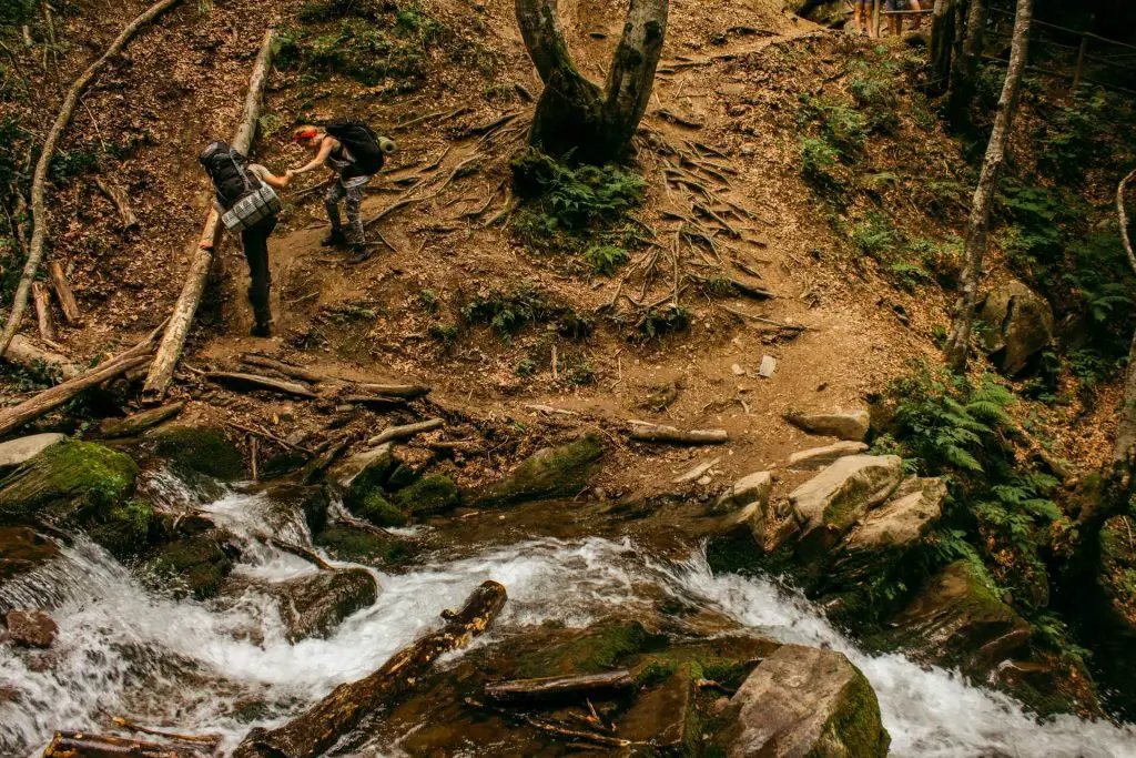 two hikers after crossing a stream