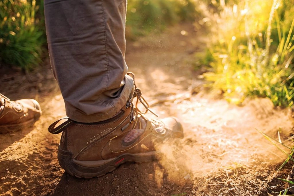 hiker's legs standing on dirt path