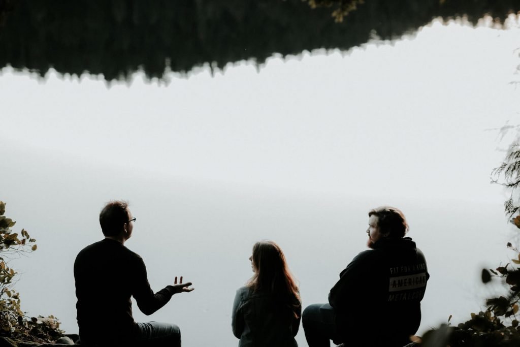 hikers talking by a lake