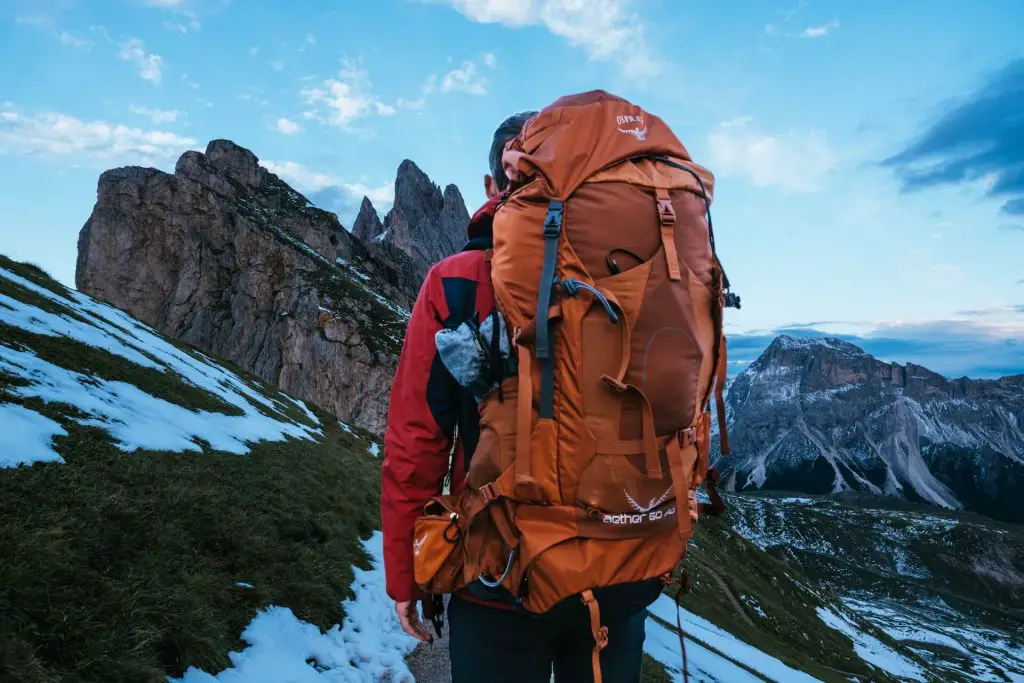 hiker with huge pack staring at mountains
