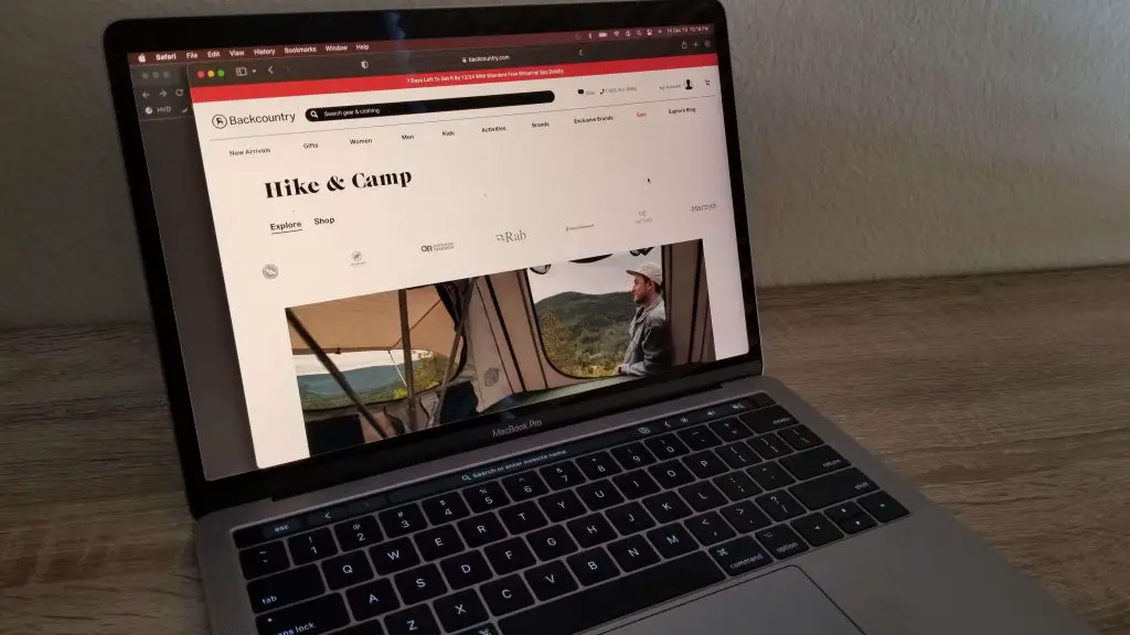 open laptop with outdoor goods website on screen