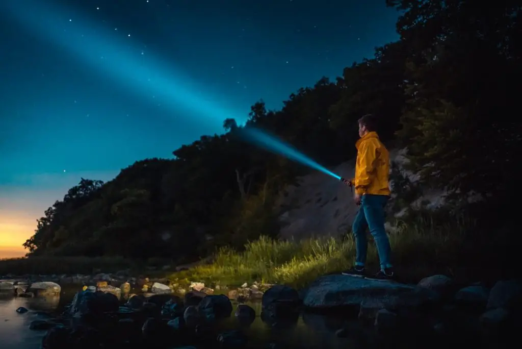 hiker holding flashlight