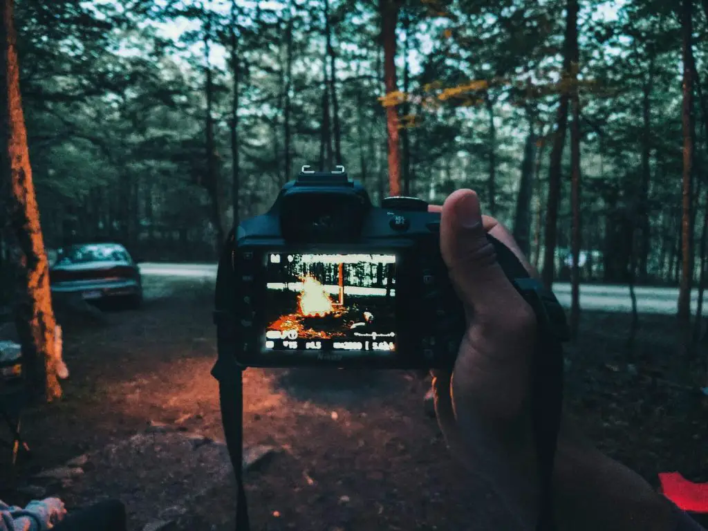 DSLR camera taking photo of campfire