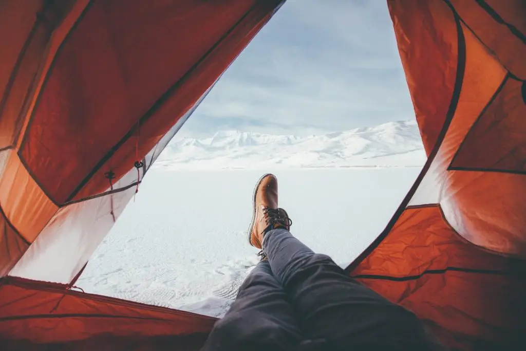 feet stretched outside of tent door