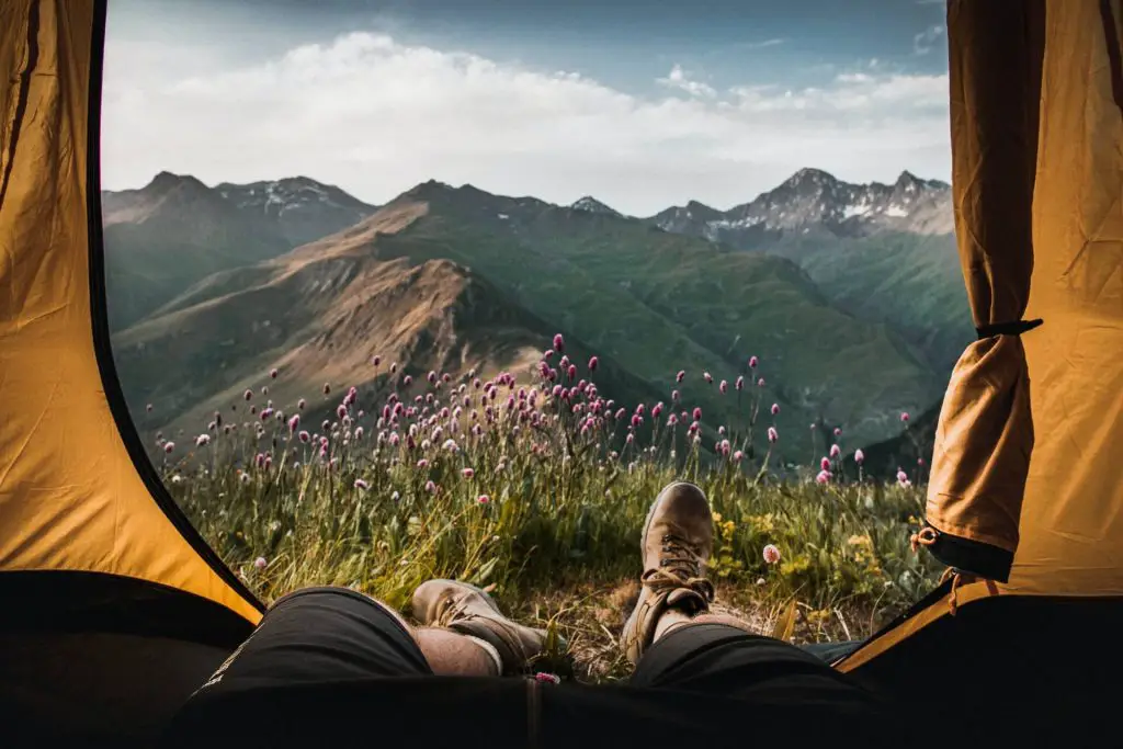 view of mountains with feet sticking out of tent