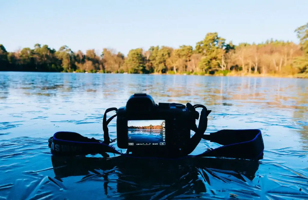 camera taking photo of lake