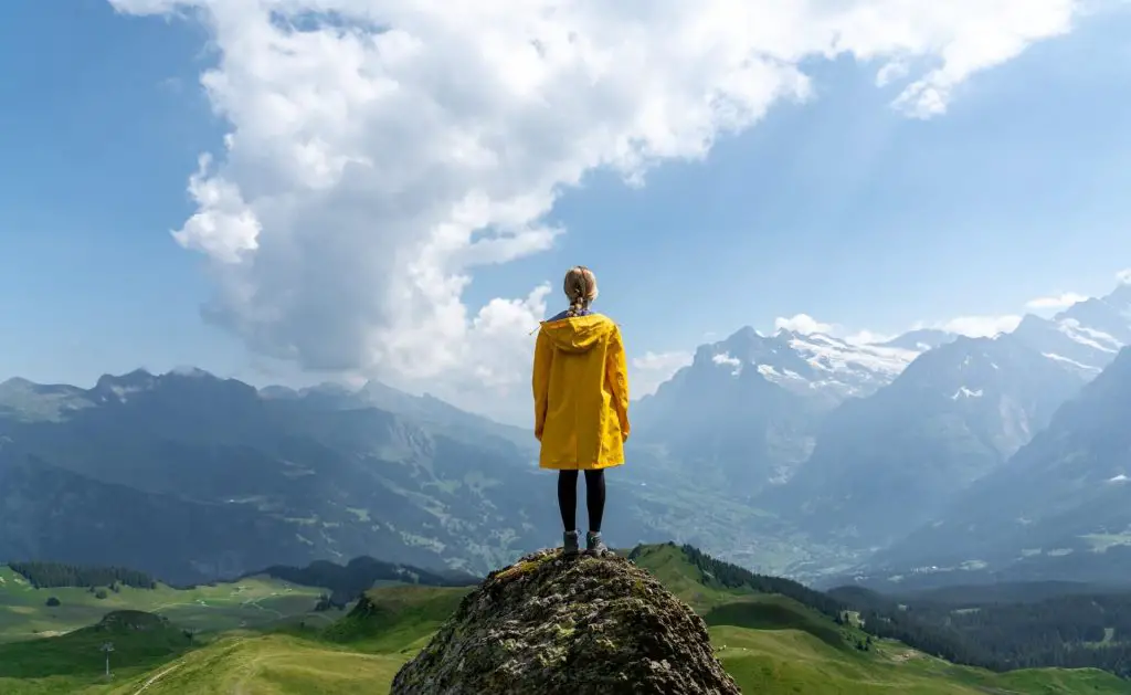 hiker in rain jacket on mountain