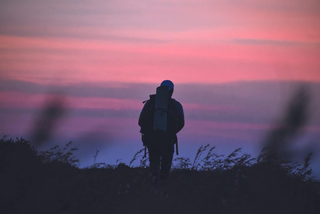 hiker in the mountains in the evening