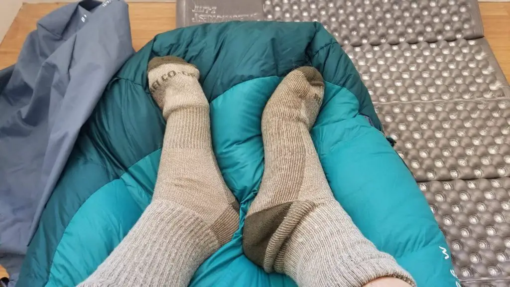 socked feet on sleeping bag