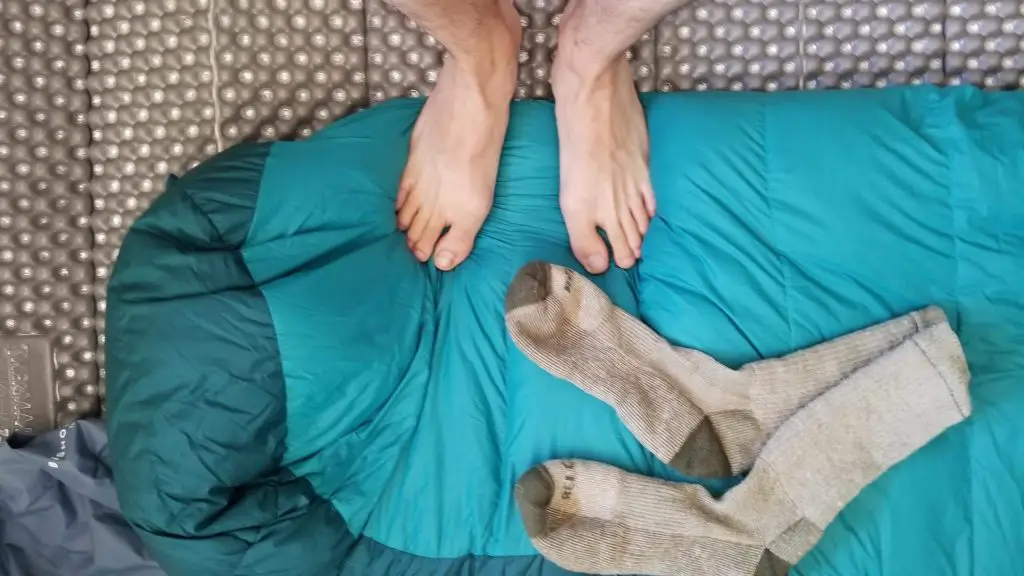 feet standing on sleeping bag