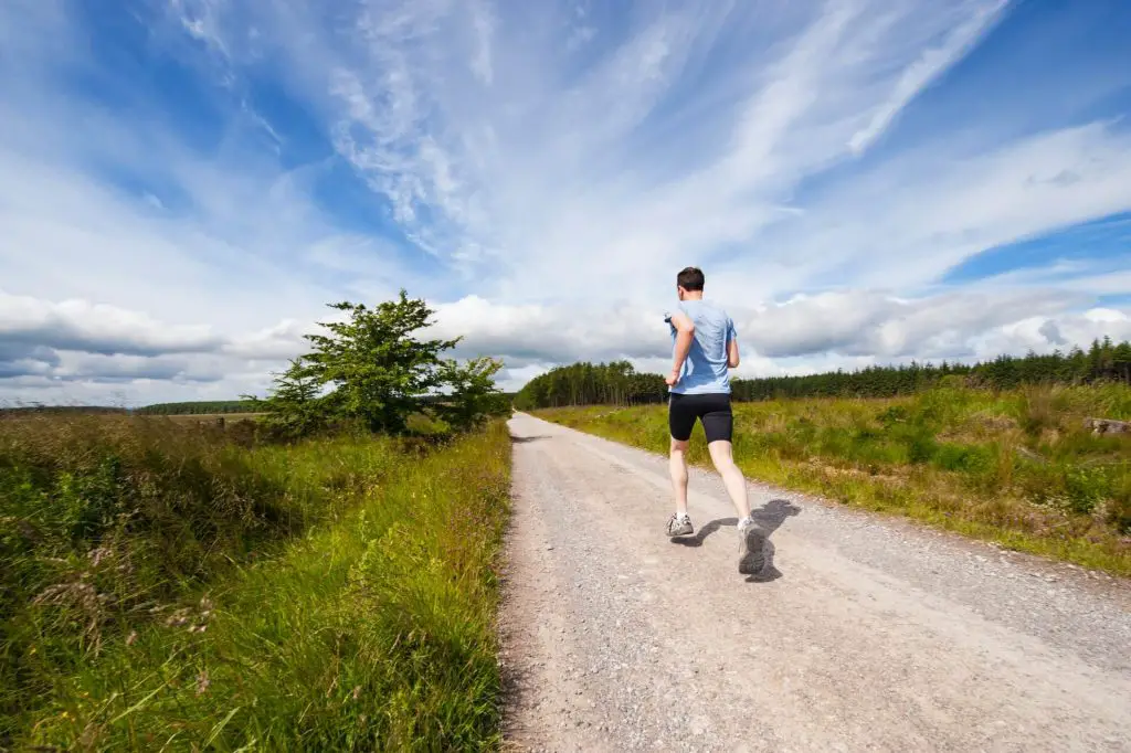 person running on hiking trail