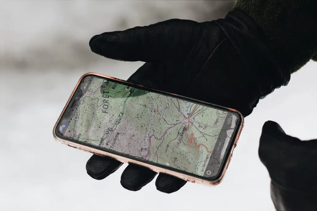 person holding smart phone with map