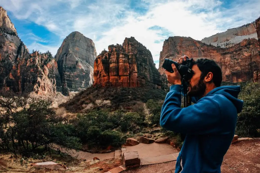 hiker taking photos at zion national park