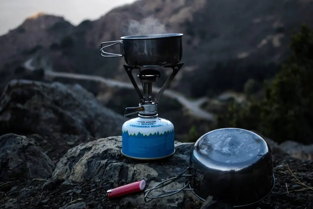 mini camping stove on rocks