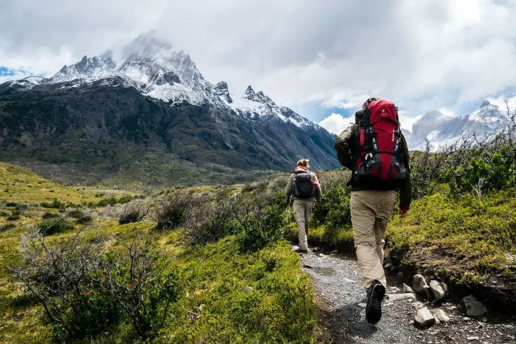 two hikers walking in mountain trail