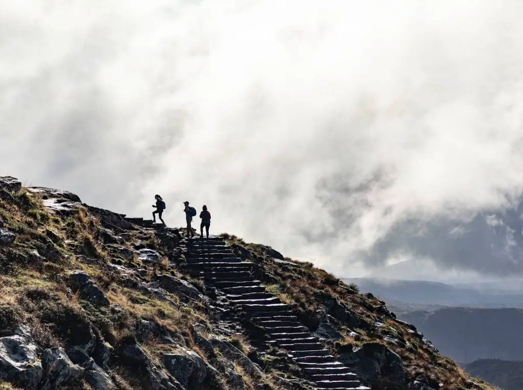 three hikers going up steep slope