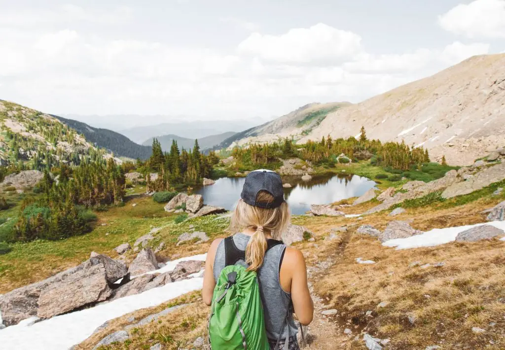 female hiker staring off at mountains