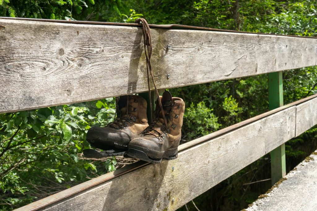leather hiking boots tied on a bridge
