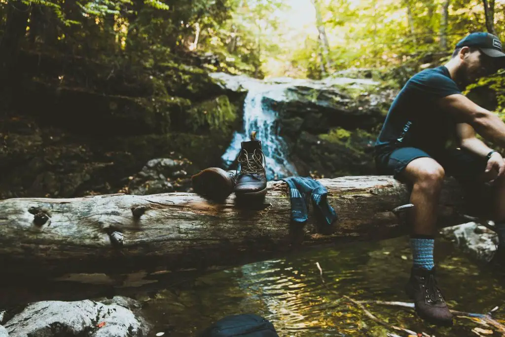 hiker with removed hiking boots and socks