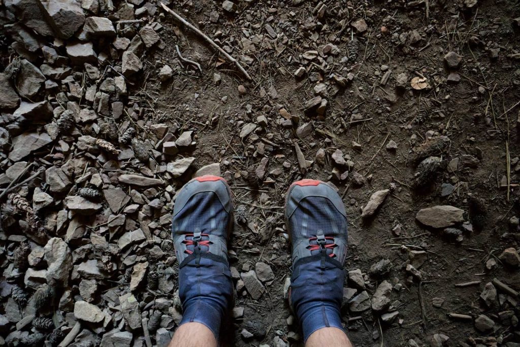 looking down at trail running shoes on dirt