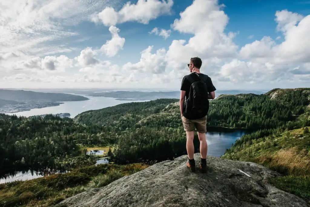 hiker enjoying views of forest and river