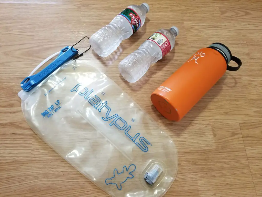 hydration bladder and bottles on the floor